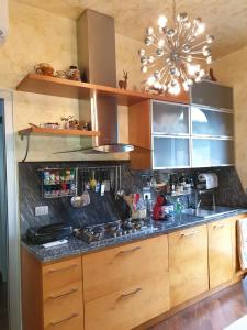 a kitchen with a stove and a sink and a chandelier at Lake House in Vergiate