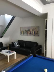 a living room with a couch and a pool table at Holiday Home Goesting in Nieuwpoort +9 photos