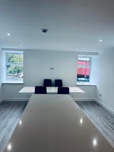 a room with two chairs and a large table at Woodside House in Crook of Alves