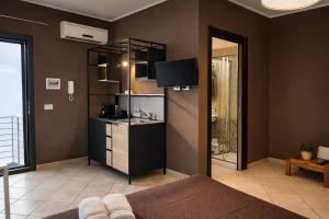 a living room with a couch and a tv at MyBed B&B in Cavallino di Lecce