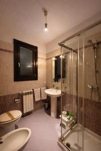 a bathroom with a glass shower and a sink at MyBed B&B in Cavallino di Lecce