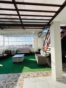 a patio with a table and couches on a building at Sun Terrace Ilo Loft in Ilo