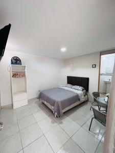 a bedroom with a bed and a table at Sun Terrace Ilo Loft in Ilo