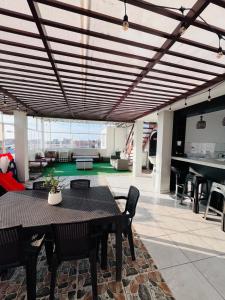 a living room with a table and chairs and pianos at Sun Terrace Ilo Loft in Ilo