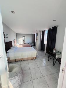 a large bedroom with a bed and a table at Sun Terrace Ilo Loft in Ilo +12 photos