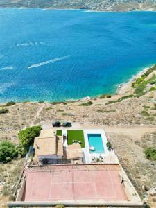 an aerial view of a house and the ocean at Villa Consta with Tennis, Saltwater Pool & Sea Views by KB Hospitality in Dhaskalión +21 photos
