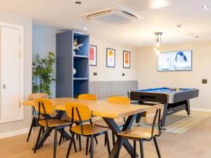 a dining room with a ping pong table and chairs at For Students Only West End in Glasgow in Glasgow