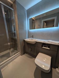 a bathroom with a toilet and a sink and a shower at For Students Only West End in Glasgow in Glasgow +4 photos
