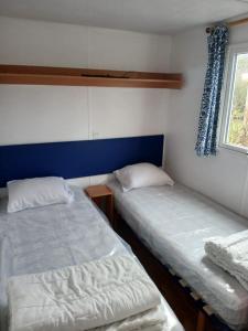 a room with two beds and a window at Escapade aux Peupliers in Vironchaux