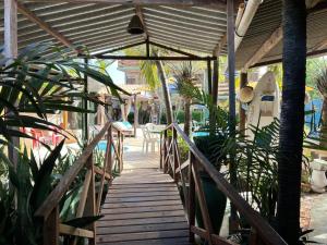 a wooden walkway leading to a patio with plants at Pousada Barumar in Lucena