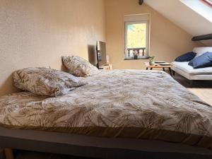 a bedroom with a large bed with pillows on it at Appartement jacuzzi et spa étoile Mystérieuse in Belfort