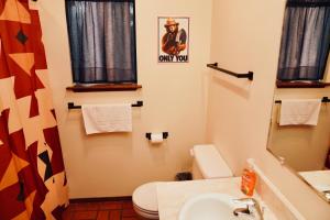 a bathroom with a toilet and a sink at Forest Glen in Yosemite West +13 photos