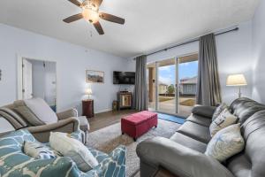a living room with couches and a ceiling fan at The Dunes 101 by Vacation Homes Collection in Fort Morgan