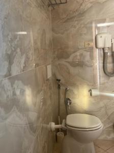 a bathroom with a toilet and a stone wall at Hotel Center 1 in Rome +44 photos
