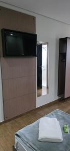 a room with a flat screen tv on a wall at Platinum Hotel in São Paulo