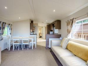 a living room with a couch and a table at The Orchard - Uk7111 in Alloa