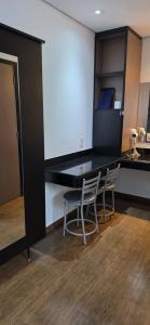 a kitchen with a table and chairs in a room at Platinum Hotel in São Paulo