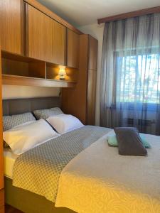 a bedroom with two beds and a window at Haus Tanja in Malinska +39 photos