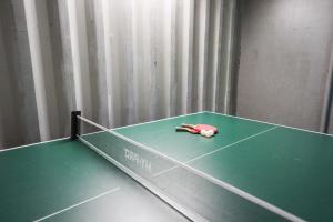 a ping pong table with a pen on top of it at Honeysuckle Cottage in Hele