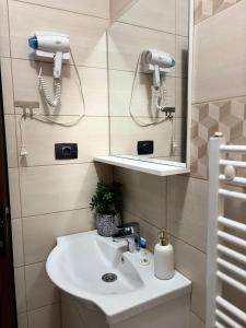 a bathroom with a sink and a mirror at Kromatic 5 Boutique Studios - Old town Center in Braşov +45 photos