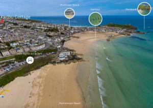an aerial view of a beach with three landmarks at Karibu - Boutique Cottage with Parking - Short walk to Beach in St Ives +37 photos