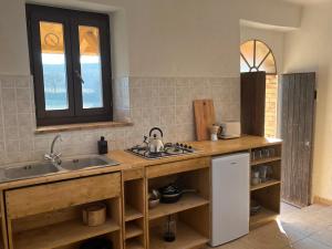 a kitchen with a sink and a counter at Vineyard Farmhouse in Massignano in Massignano