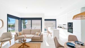a living room with a couch and a table at Villa Horizonte in Finestrat