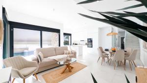 a living room with a couch and a table at Villa Horizonte in Finestrat