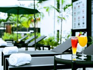 two cocktails sitting on a table on a patio at Aurum on Missouri in Abuja