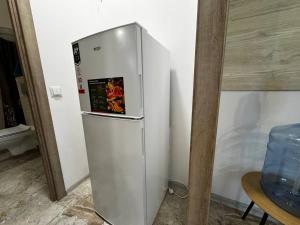 a silver refrigerator in a corner of a room at Bilia Tustani in Urych