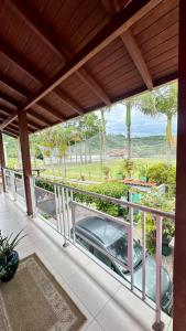 a balcony with a car parked on a porch at Residencial Zirke in Florianópolis