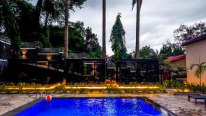 a swimming pool with a christmas tree in the background at Aurum on Missouri in Abuja