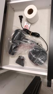 a box with a charger and a roll of toilet paper at One Bedroom Apartment with Terrace in Oradea