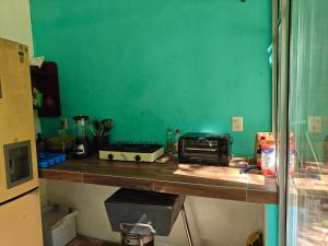 a kitchen with a counter with a toaster and a toaster at Bacalar La Fortuna Cabañas a 300m de la Laguna in Bacalar +39 photos