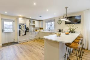 a kitchen with white cabinets and a large island at 3 Bed in Callaughton oc-b34809 in Much Wenlock