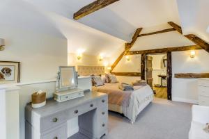 a bedroom with a bed and a desk with a tv at 3 Bed in Callaughton oc-b34809 in Much Wenlock