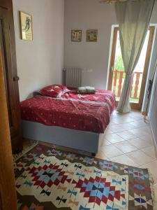 a bedroom with a bed and a rug on the floor at Beautiful chalet accommodation with covered parking in Cianfuran
