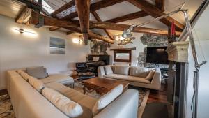 a living room with a couch and a table at Dolomites Luxury Penthouse in Agordo
