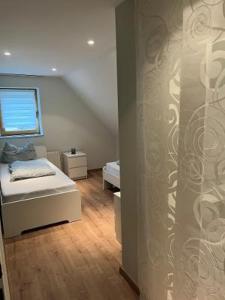 a small bedroom with a bed and a window at CasaCremer 3 in Übach-Palenberg