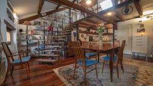 a dining room with a wooden table and chairs at Dolomites Luxury Penthouse in Agordo