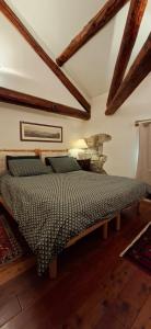 a bedroom with a bed in a room with wooden beams at Dolomites Luxury Penthouse in Agordo