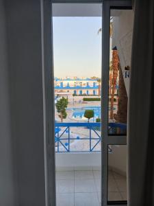 an open door to a balcony with a view of a courtyard at Regency Hotel Sharm in Sharm El Sheikh