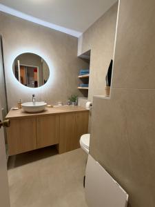 a bathroom with a sink and a mirror at Appartement Eléa, Vue sur Mer, T1 sur Fréjus à 150m des plages in Fréjus +15 photos