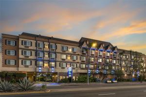 a building on the corner of a street at night at Best Western Airpark Hotel - LAX Airport LA Stadium in Inglewood
