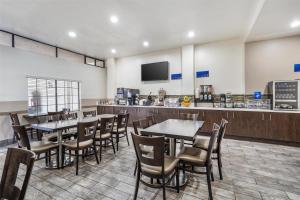 a restaurant with tables and chairs and a counter at Best Western Airpark Hotel - LAX Airport LA Stadium in Inglewood