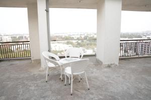 two chairs and a table on a balcony at 2bhk penthouse with open tarace in Vadodara