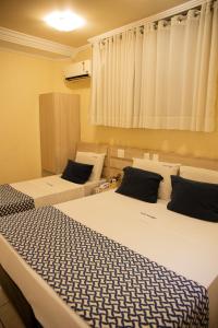 a room with two beds in a room at Polar Rio Hotel in São Paulo