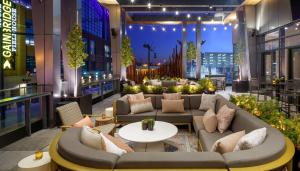 a lobby with couches and tables on a building at Hyatt House Indianapolis Downtown in Indianapolis