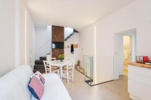 a living room with a white couch and a table at Seafront Apartments in Monopoli Old Town in Monopoli