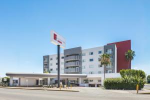 a building with a sign in front of it at Fiesta Inn Express Hermosillo in Hermosillo